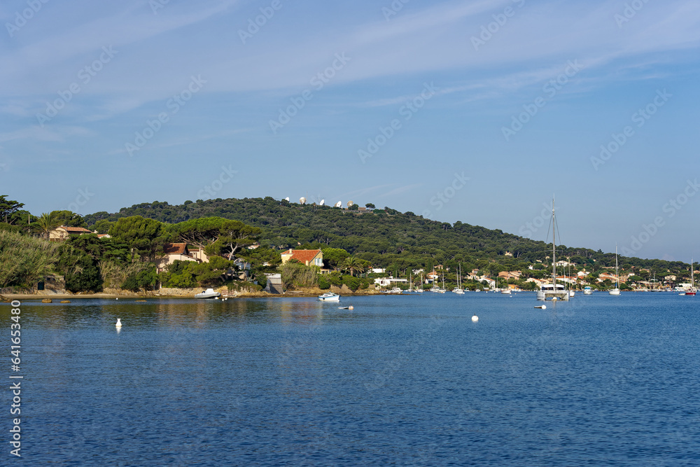 Moored motor boats and sailing boats at bay of Giens Peninsula on a sunny late spring morning. Photo taken June 8th, 2023, Giens, Hyères, France.
