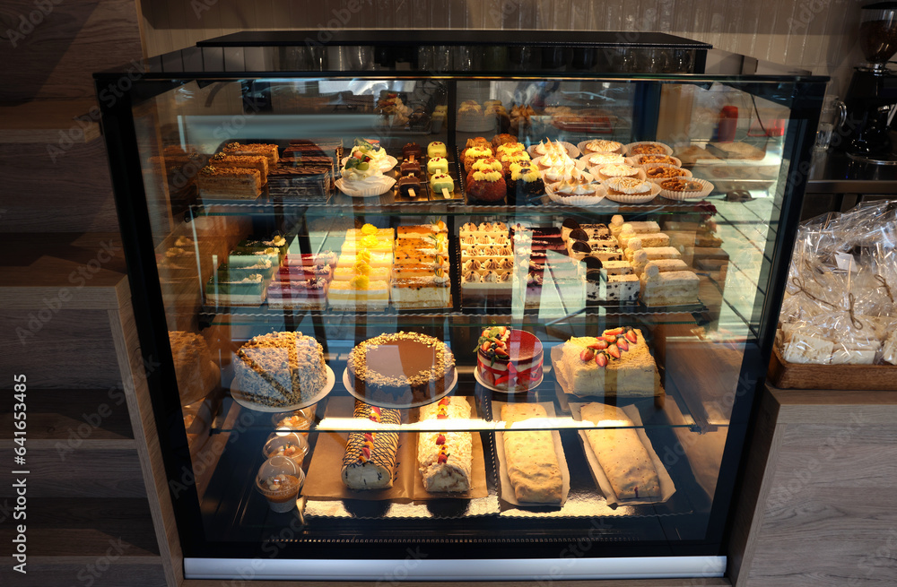 Counter with different tasty desserts in bakery shop