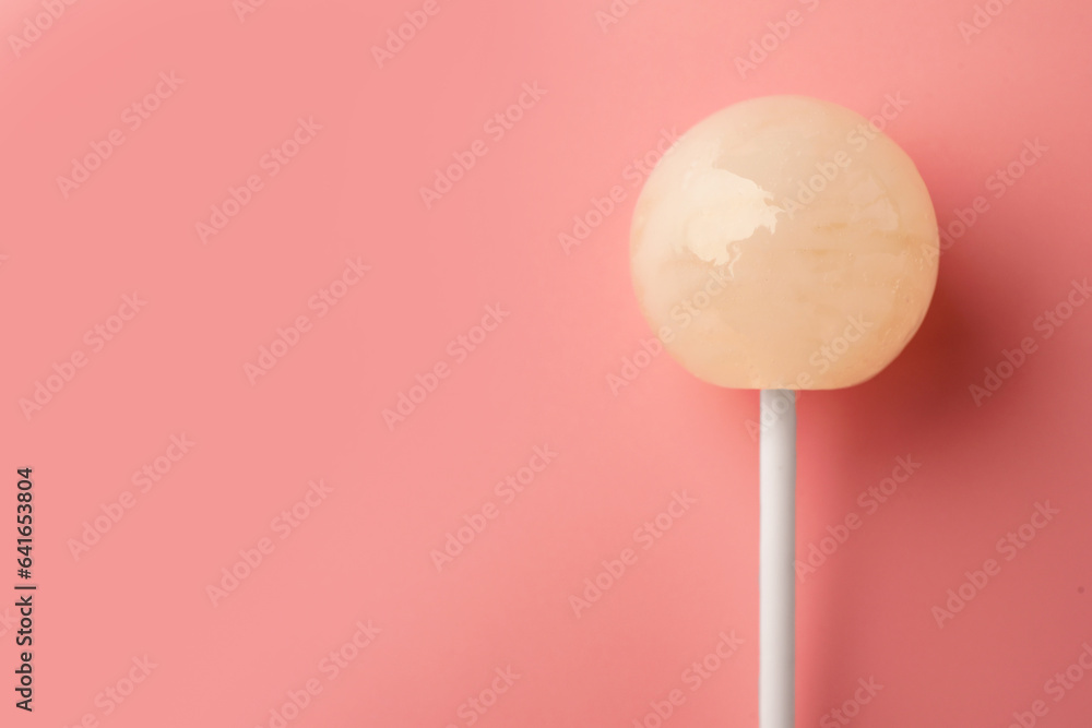 One tasty lollipop on pink background, top view. Space for text One tasty lollipop on pink background, top view. Space for text