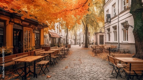 Cozy autumn cafe terrace with cobblestones and leaves