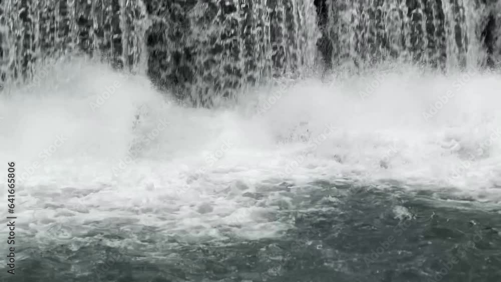 waterfall splashing into a river closeup waterfall splashing into a river closeup