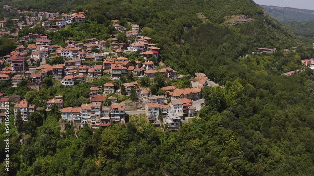 Hillside city of Veliko Tarnovo among green woodland aerial panorama Hillside city of Veliko Tarnovo among green woodland aerial panorama