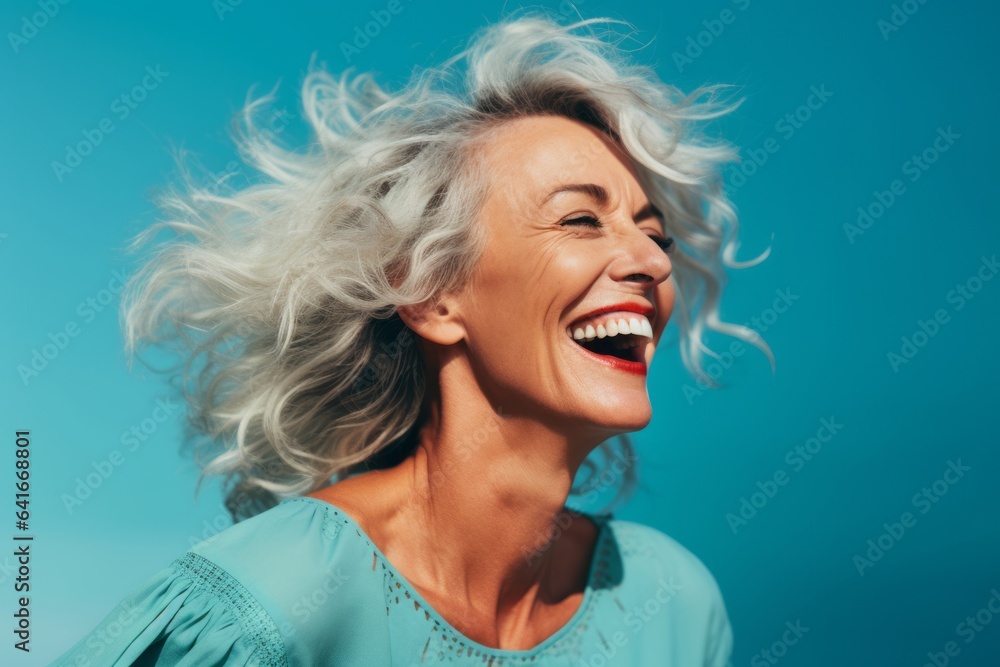Closeup portrait photography of a happy mature woman touching her hair