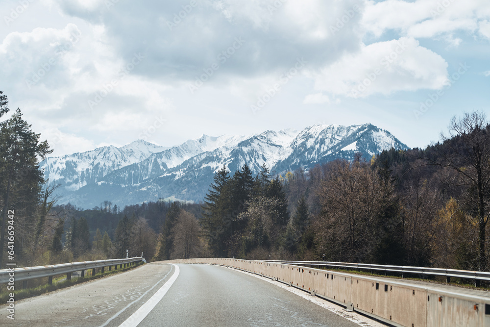 Scenic Mountain Road Landscape. A Stunning Highway Journey through Colorful Nature in Europe. Nature landscape on a beautiful highway. car driving on the highway in spring.