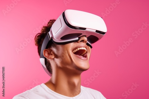 Lifestyle portrait photography of a grinning boy in his 20s playing with virtual reality mask against a peachy pink background. With generative AI technology © Markus Schröder