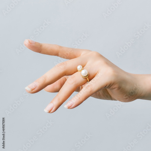 Pearl ring on a girl's finger.