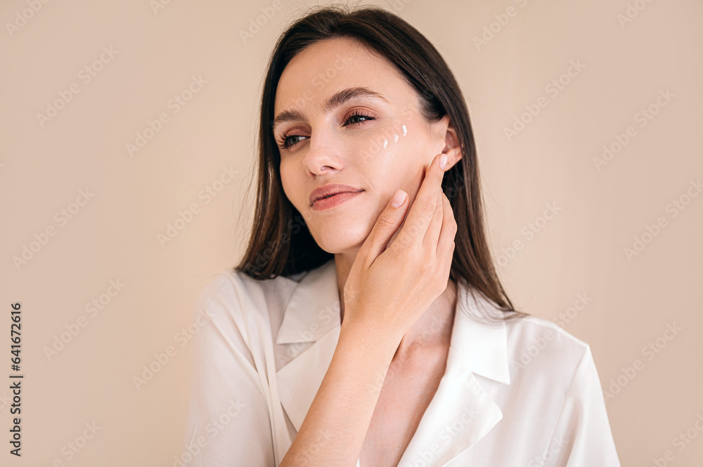 Smiling woman with perfect skin touching her face Smiling woman with perfect skin touching her face