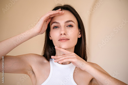 Fotografia, Obraz Portrait of young woman posing, looking at camera