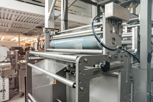 Processing of Packaging equipment thermoformer on food vacuum packaging sealing machine in industrial factory. Packing food in production line. Vacuum machine