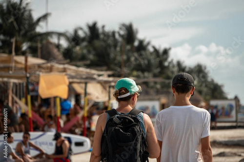 mother and son are walking in the streets of isla holbox, mexico
