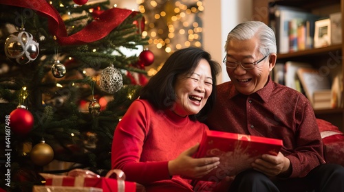 Joyful Senior Asian Couple Celebrating Christmas by the Tree. Generative AI