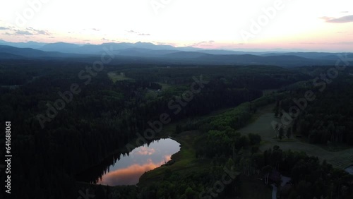 Sunset drone shot of the Rocky Mountains and forest in the foreground. Canada, Alberta. photo