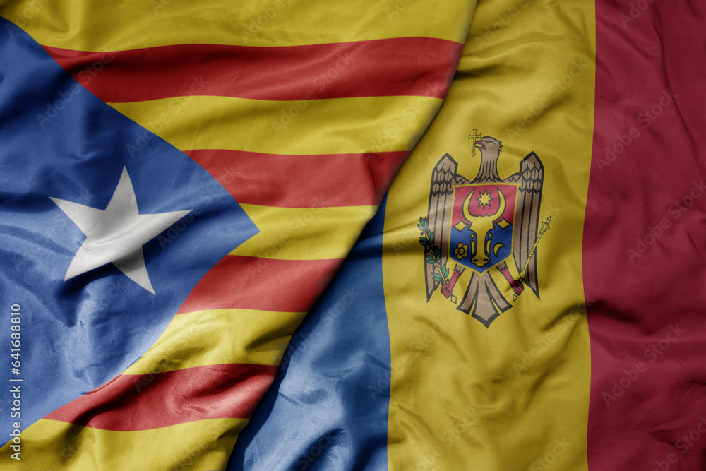 Fototapeta premium big waving national colorful flag of catalonia and national flag of moldova .