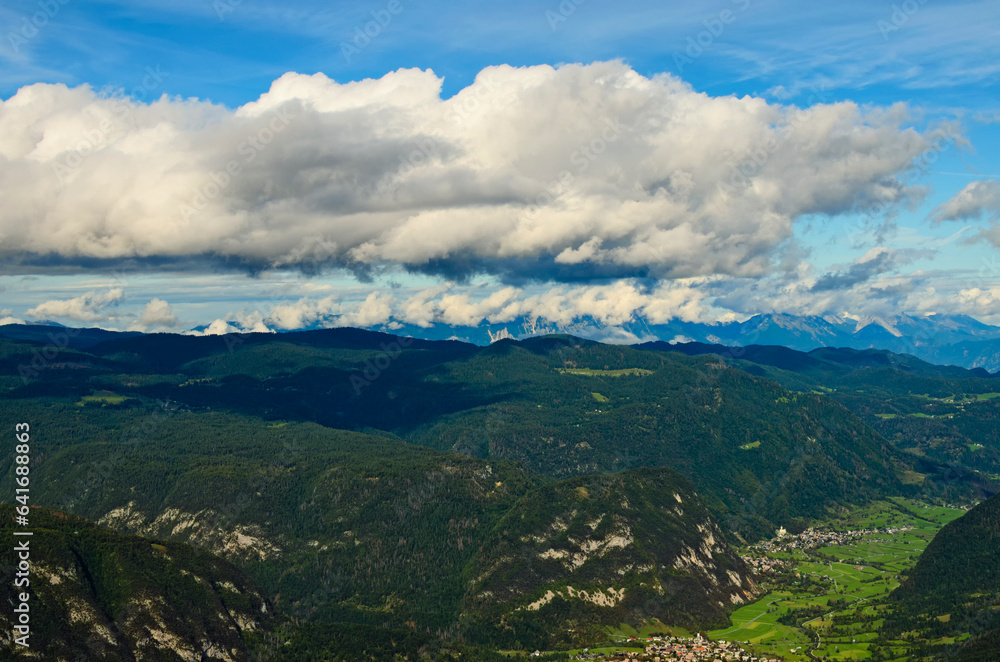 Aerial nature landscape with heavy white clouds hang over beautiful mountain range. Landscape during the autumn season. Travel and tourism concept. Triglav National Park, Slovenia