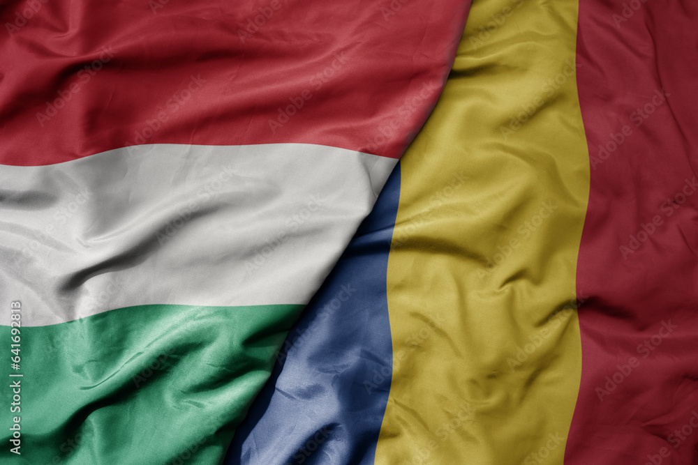 Obraz na płótnie big waving national colorful flag of hungary and national flag of romania . w salonie