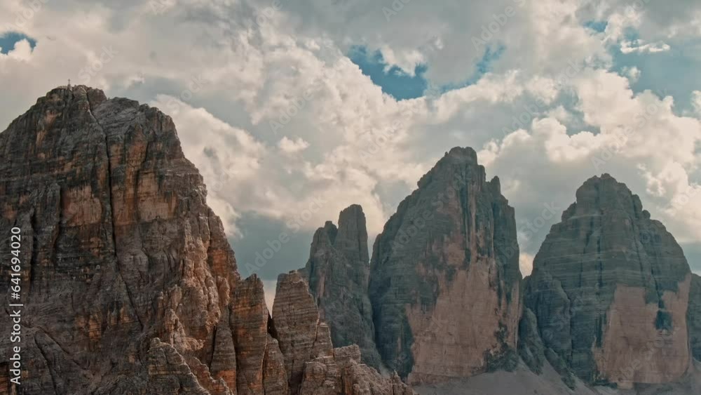 Aerial establishing view of the Tre Cime National Park or Three Peaks of Lavaredo beautiful epic mountain peaks. Travel exploring Alps Dolomites Italy nature outdoor Aerial establishing view of the Tre Cime National Park or Three Peaks of Lavaredo beautiful epic mountain peaks. Travel exploring Alps Dolomites Italy nature outdoor
