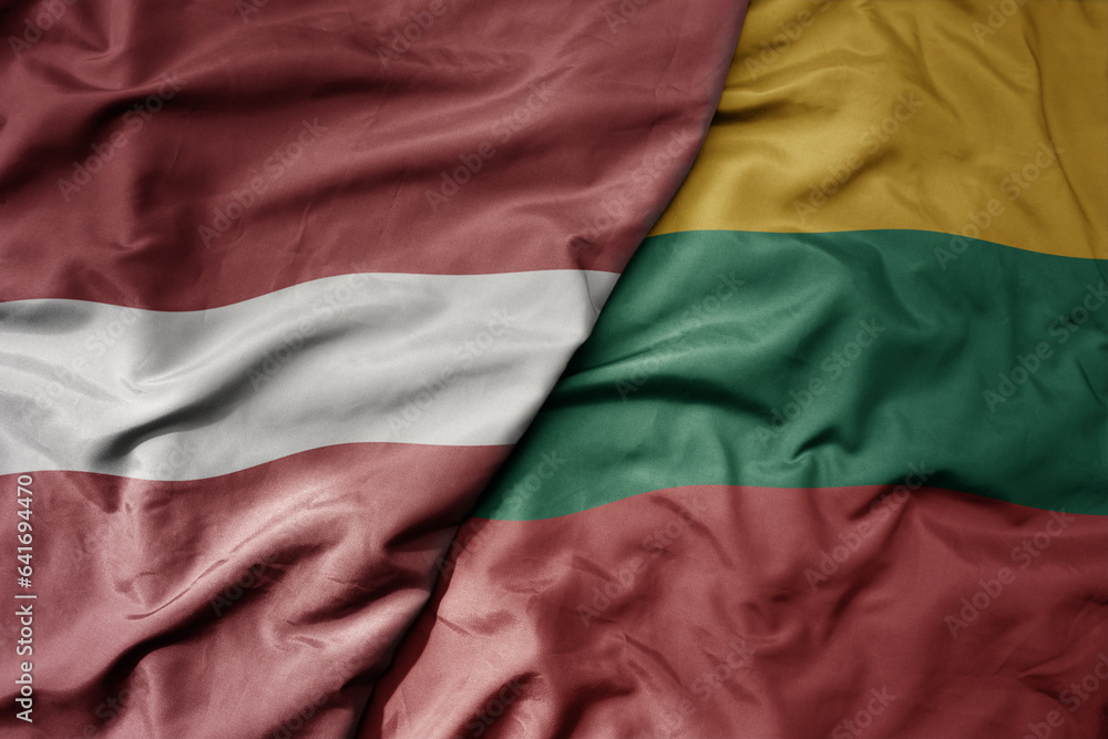 big waving national colorful flag of latvia and national flag of lithuania .