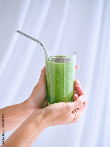 Unrecognizable person with glass of smoothie