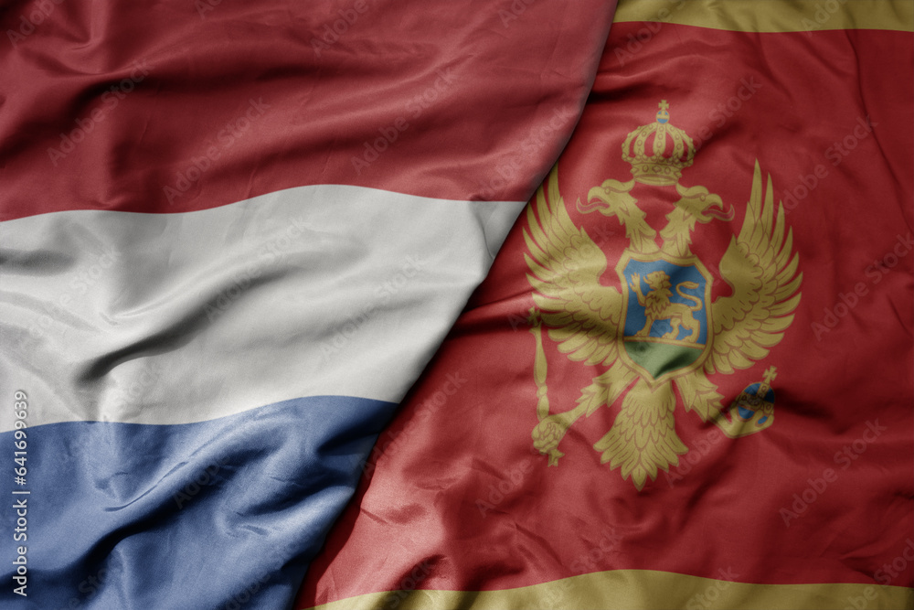 big waving national colorful flag of netherlands and national flag of montenegro . big waving national colorful flag of netherlands and national flag of montenegro .