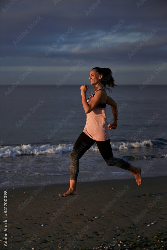 Content Hispanic woman running on sandy shore