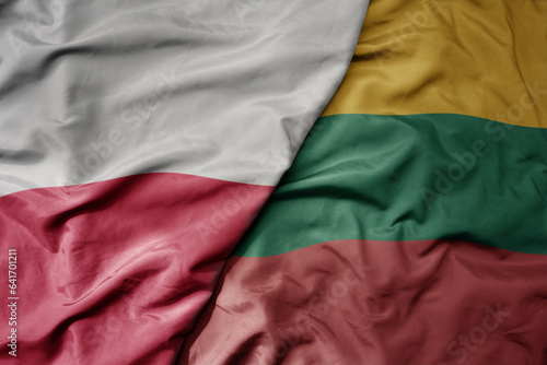 big waving national colorful flag of poland and national flag of lithuania .