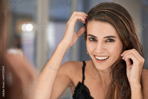 Smiling woman looking at mirror
