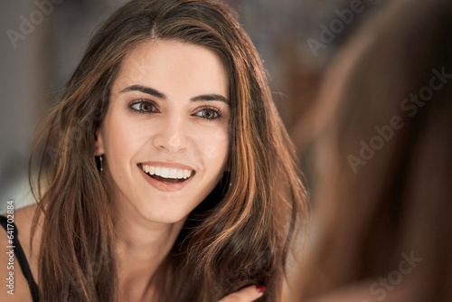 Delighted woman looking at mirror in studio