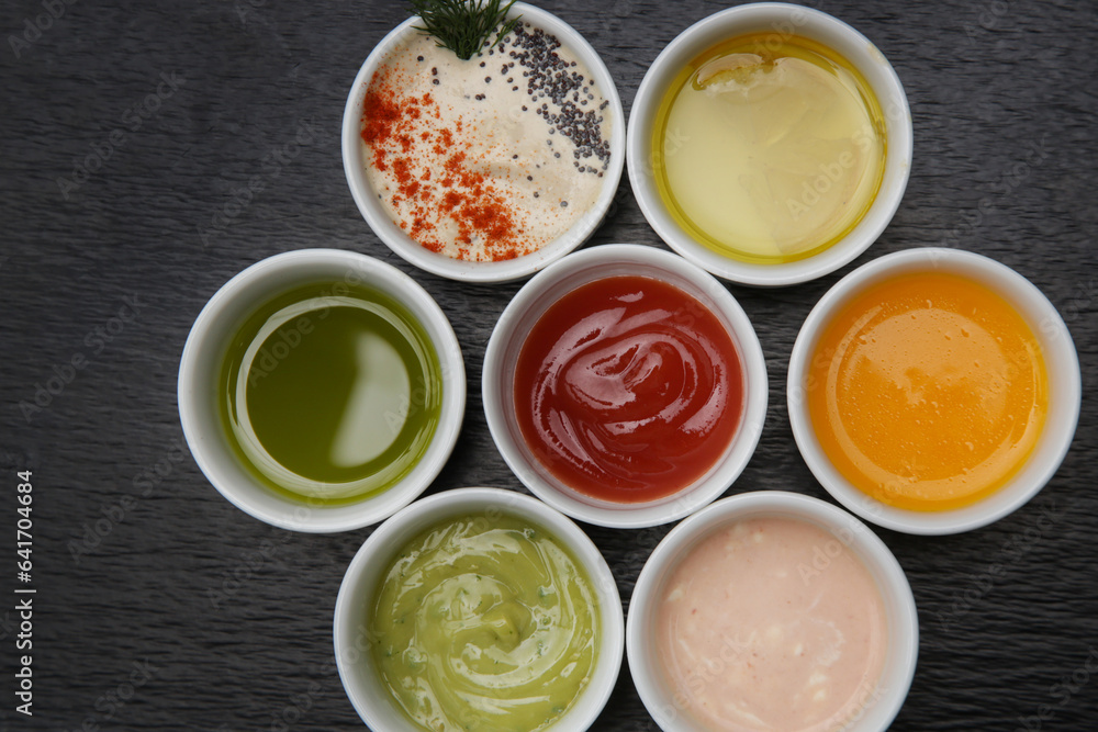 Different sauces and dips in bowls on the restaurant table Different sauces and dips in bowls on the restaurant table