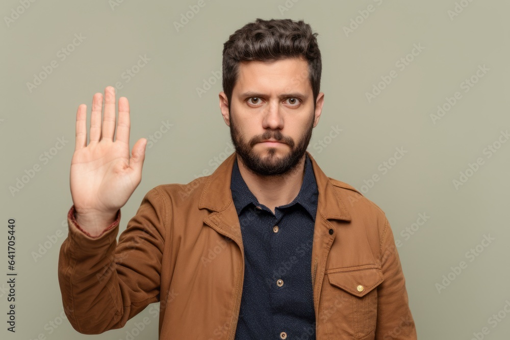 Headshot portrait photography of a satisfied boy in his 30s making a no or stop gesture with the extended palm against a beige background. With generative AI technology Headshot portrait photography of a satisfied boy in his 30s making a no or stop gesture with the extended palm against a beige background. With generative AI technology