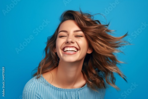 Close-up portrait photography of a joyful girl in her 30s giving a hug to the camera against a periwinkle blue background. With generative AI technology