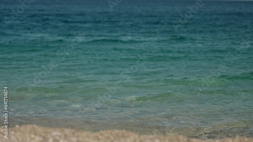 slow motion footage tropical island and sea waves crashing and foaming against pebble rocky beach. rocks coast meeting deep blue ocean water. Tourism in Turkey concept photo