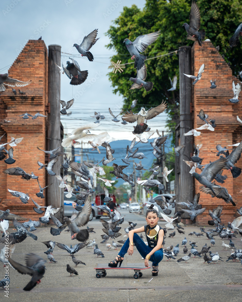 Obraz premium Pretty teenage young Asian women in a modern dress fashion contemporary is posted at Tha Phae Gate, a Landmark of the old city of Chang Mai, Thailand.