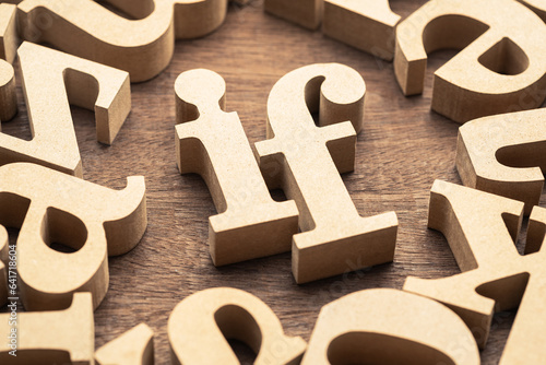 Closeup the IF word in the group of wooden English alphabets, learning conjunction in English language, success solution and vision, or Intermittent Fasting (IF) diet method