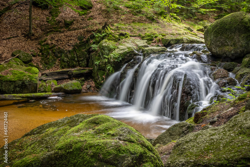 Long exposure of stream waterfalls in summer forest