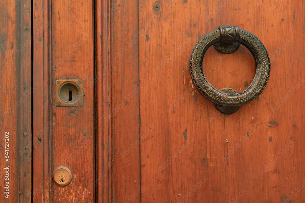 Fragment of an old wooden door with a metal handle. Fragment of an old wooden door with a metal handle.