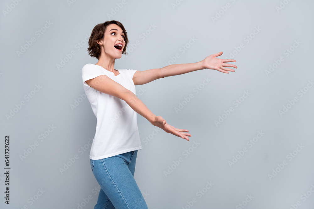Profile photo of cheerful impressed girl open mouth raise hands catch empty space ad isolated on grey color background