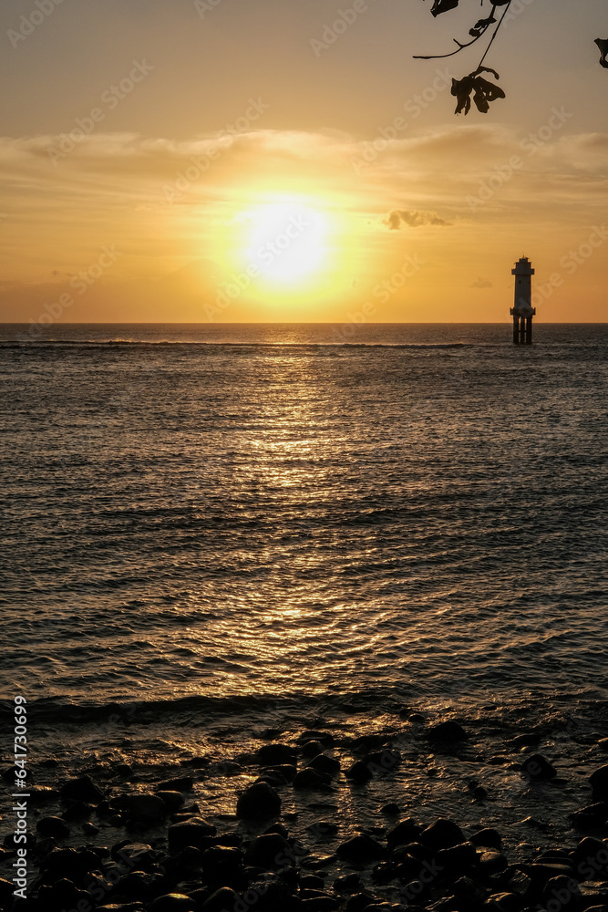 Fototapeta premium sunset view at senggigi lombok beach with the silhouette of mount agung bali, sunset over the sea, sunset at the beach, sunset and mountain, lighthouse at sea, sunset on the sea, senggigi lombok
