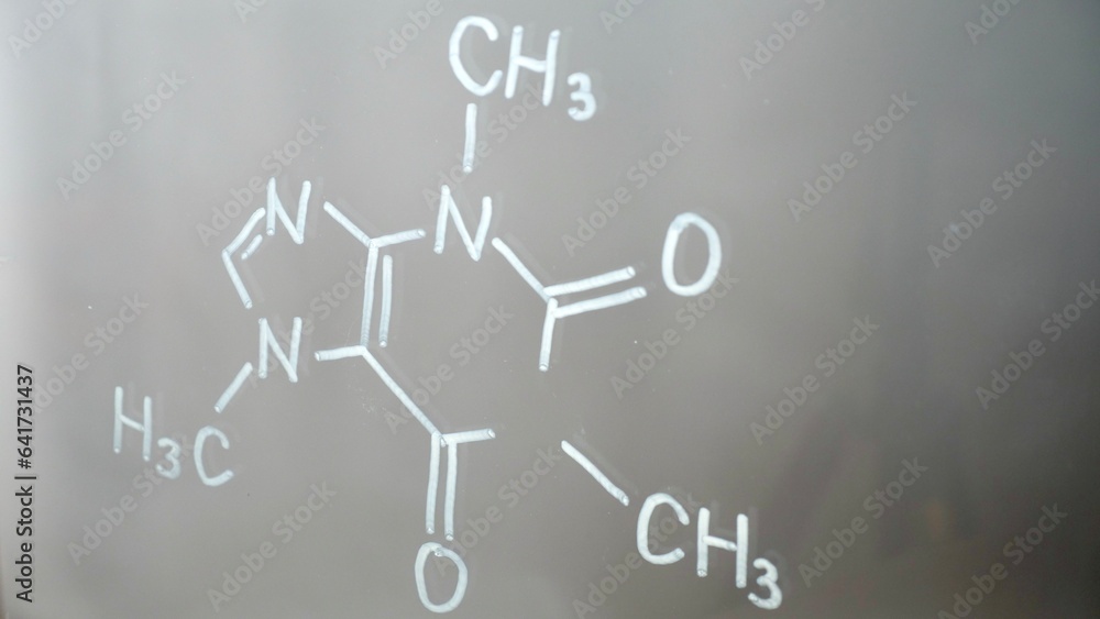 Fototapeta premium Chemical structure, formula of caffeine on glass in the lab close-up. Lecture on chemistry