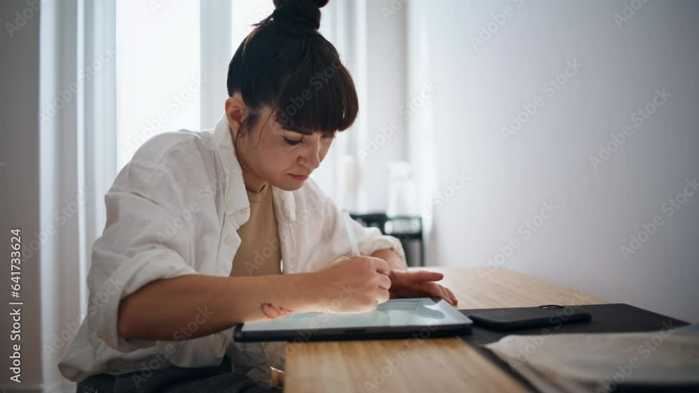 Tattoo artist drawing sketch at cozy place closeup. Woman using graphic tablet Tattoo artist drawing sketch at cozy place closeup. Woman using graphic tablet
