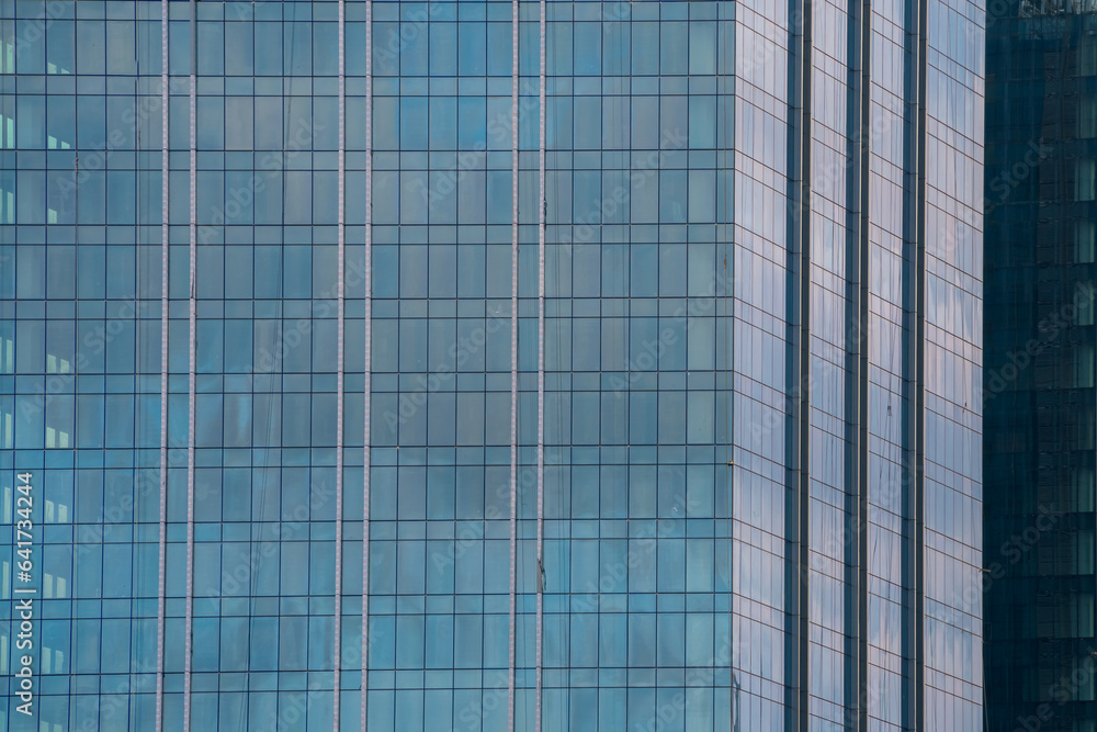 Glass facade of modern city high rise, buildings Glowing windows of skyscrapers. Glass facade of modern city high rise, buildings Glowing windows of skyscrapers.