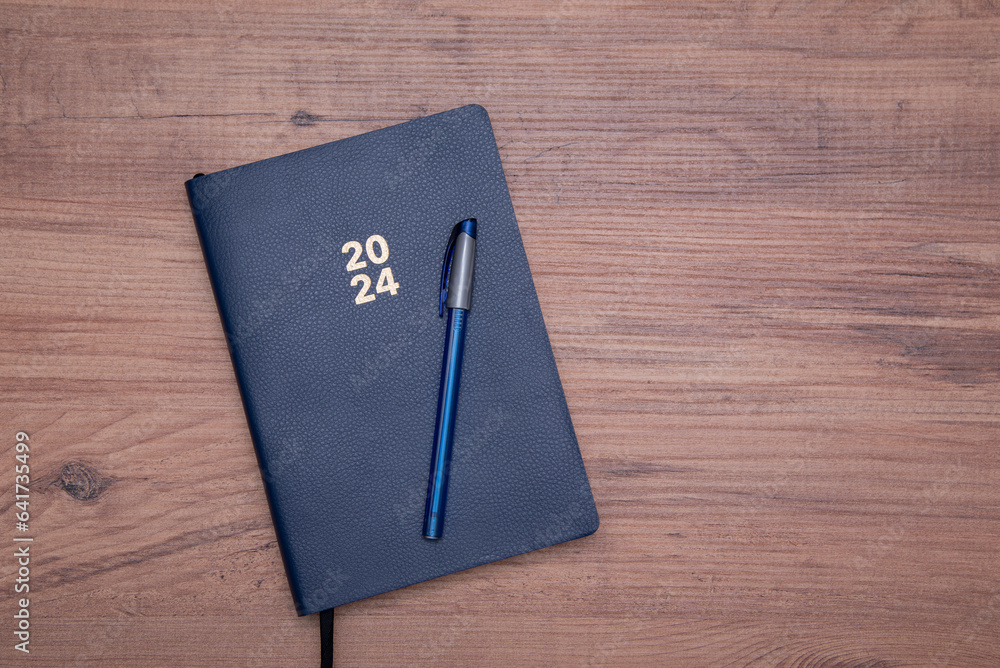 notebook, pen on wooden background notebook, pen on wooden background