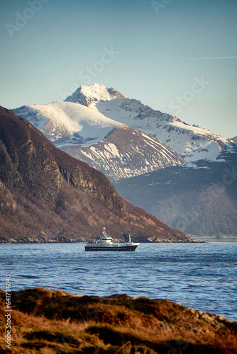Fishing vessel in front of the Sunnmøre Alps seen from Godøy, Ålesund, Norway