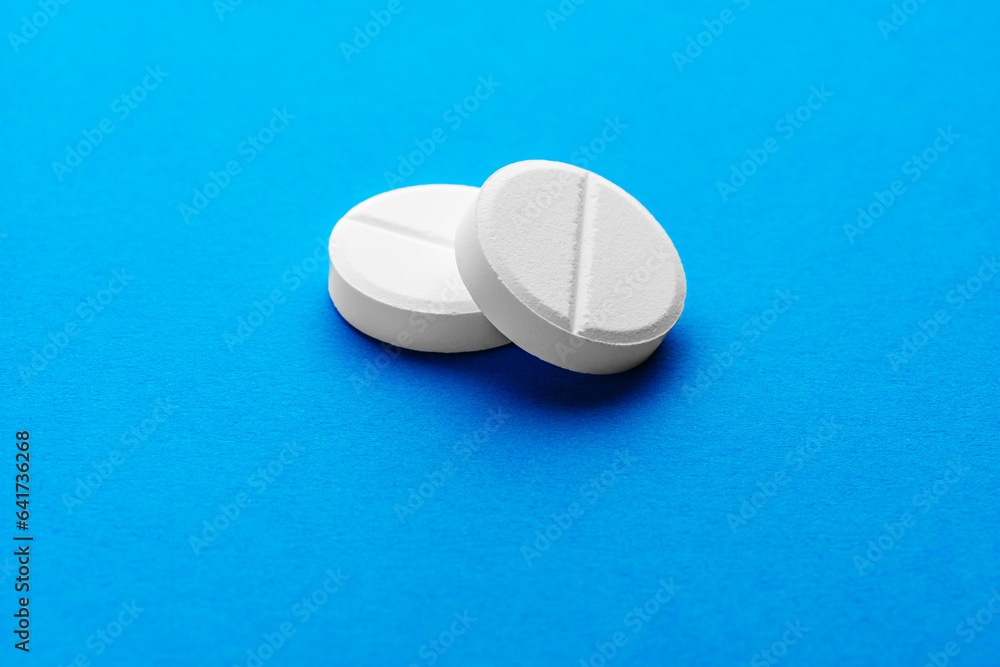 two large white effervescent tablets on a bright blue background two large white effervescent tablets on a bright blue background