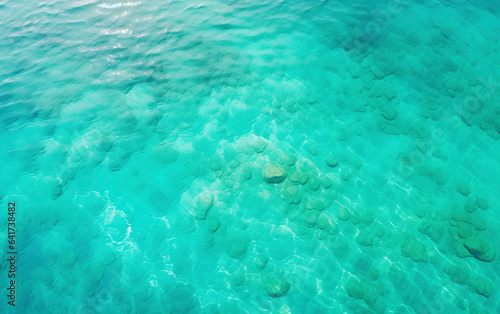 Calm clear blue sea water background. Blue azure sea water texture © Lemar