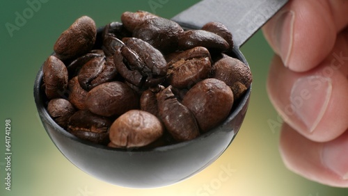 Coffee beans with spoon and glass ready to be served