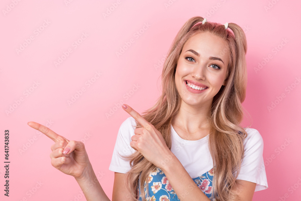 Photo portrait of attractive young woman point empty space promotion wear trendy flower print clothes isolated on pink color background Photo portrait of attractive young woman point empty space promotion wear trendy flower print clothes isolated on pink color background