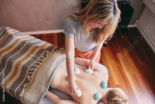 Therapist doing a cupping treatment on a patient photo