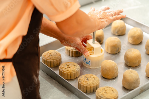 Mooncake making process. A mooncake  is a Chinese bakery product traditionally eaten during the Mid-Autumn Festival.