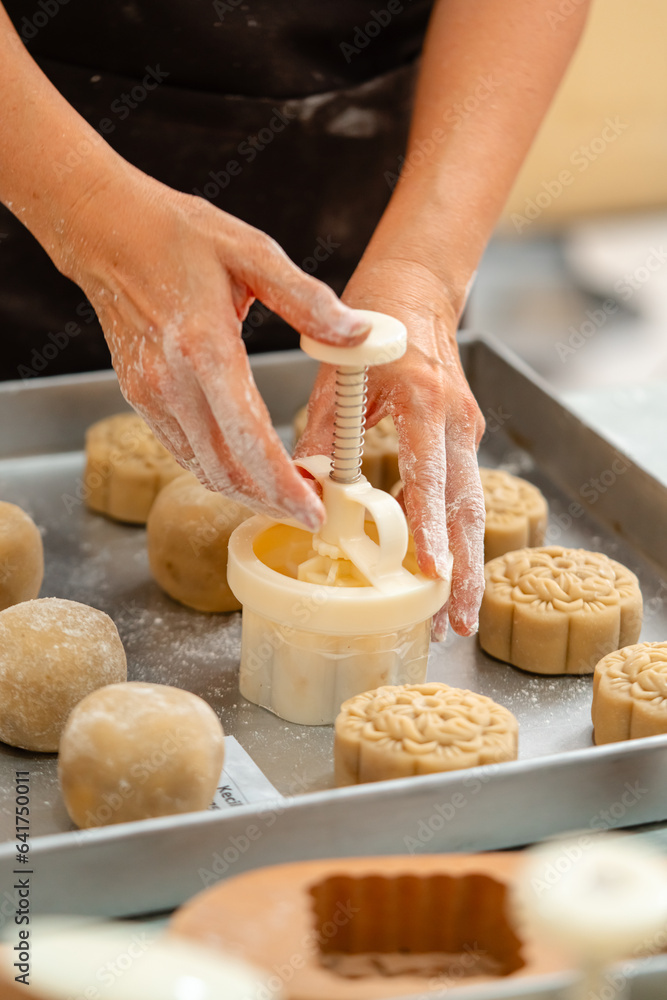 Mooncake making process. A mooncake  is a Chinese bakery product traditionally eaten during the Mid-Autumn Festival.