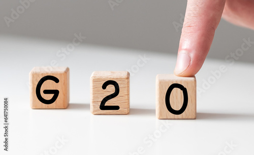 G20. Politics, economics and the concept of cooperation. Magnifying glass on a white background.
